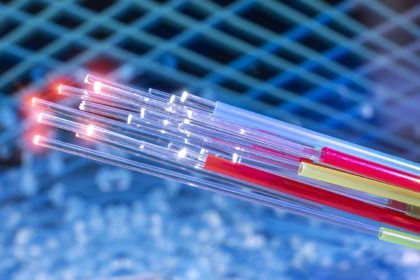 Fiber optics network cable on technology background